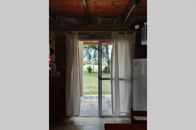 an open door into a kitchen with a door to a yard at Campos de Dios in Potrero de Garay