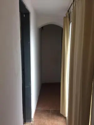 an empty hallway with a door and a curtain at Gimenoz Apart in Nono
