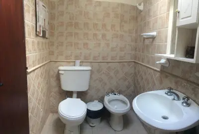 a bathroom with a toilet and a sink at Gimenoz Apart in Nono