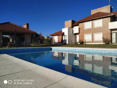 a swimming pool in front of some houses at Mirador Suites & Aptos in Villa General Belgrano