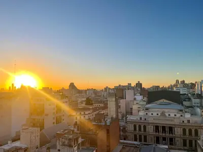 a view of a city at sunset at Departamento enorme sobre Cañada Patio Olmos in Cordoba