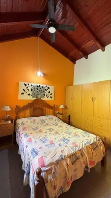 a bedroom with a bed and a ceiling fan at Ariel Reynoso - Departamento Planta Baja in Mina Clavero