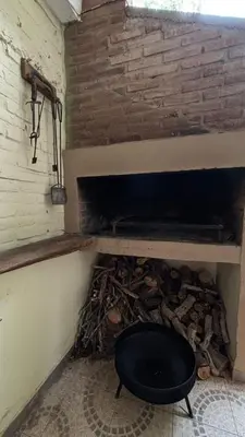 a brick fireplace with a black object in it at Ariel Reynoso - Departamento Planta Baja in Mina Clavero