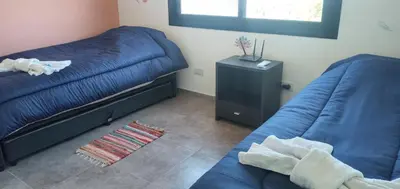 a bedroom with two beds and a night stand at Alma Valiente in Merlo