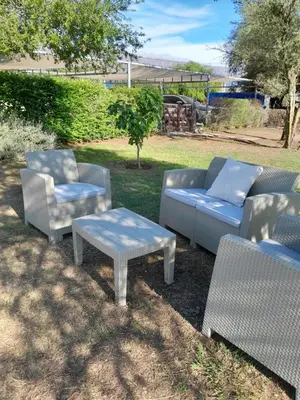 a group of chairs and tables in a yard at Alma Valiente in Merlo