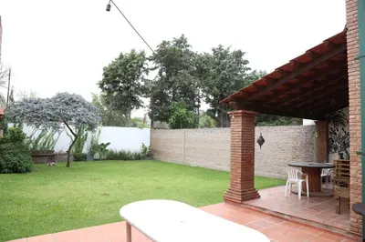 a patio with a table and a brick wall at Casa en Córdoba in Cordoba