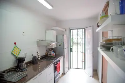 a kitchen with white counters and a stove top oven at Casa en Córdoba in Cordoba