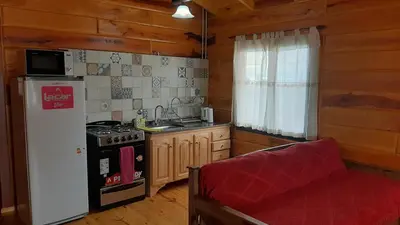 a kitchen with a refrigerator and a stove top oven at Complejo Apus in La Cumbrecita