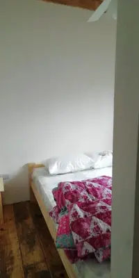 a bed in a room with a white wall at Las zarinas 2 in Trapiche