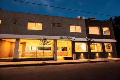 a building on a street at night with lights at Hotel Las Piedras in Villa Cura Brochero