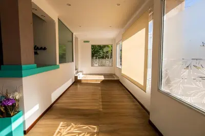 a hallway of a house with wooden floors and a window at Hotel Las Piedras in Villa Cura Brochero