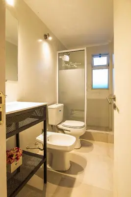 a bathroom with a toilet and a shower and a sink at Hotel Las Piedras in Villa Cura Brochero