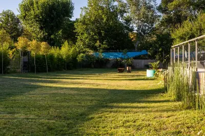 a yard with a fence and grass and trees at Hotel Las Piedras in Villa Cura Brochero