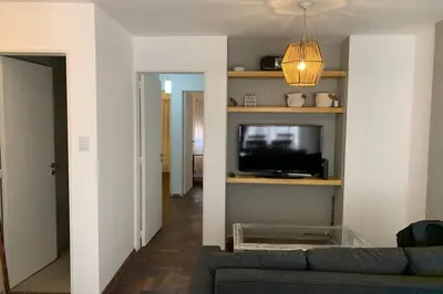 a living room with a couch and a flat screen tv at Departamento en Nueva Cordoba, 2 dormitorios in Cordoba