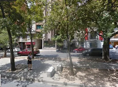 a person standing on a street in a city at Departamento en Nueva Cordoba, 2 dormitorios in Cordoba