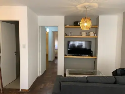 a living room with a couch and a flat screen tv at Departamento en Nueva Cordoba, 2 dormitorios in Cordoba