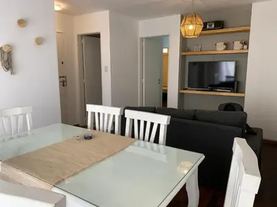 a living room with a glass table and a couch at Departamento en Nueva Cordoba, 2 dormitorios in Cordoba