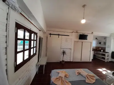 a kitchen with two robes on a table in a room at El mirador de estrellas in Santa Rosa de Calamuchita