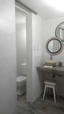 a bathroom with a toilet and a sink and a mirror at El mirador de estrellas in Santa Rosa de Calamuchita