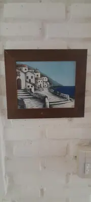 a mirror on a wall with a picture of a village at El mirador de estrellas in Santa Rosa de Calamuchita