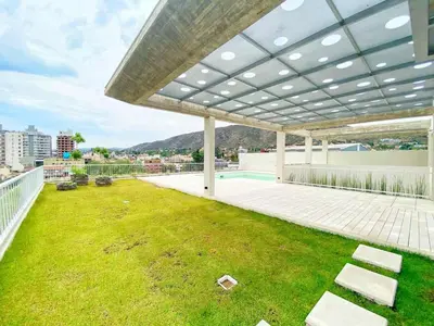 a large outdoor patio with a grass yard at Stefano IV in Villa Carlos Paz