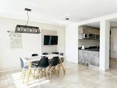 a kitchen and dining room with a table and chairs at Stefano IV in Villa Carlos Paz