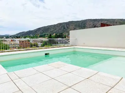 a swimming pool with a view of a mountain at Stefano IV in Villa Carlos Paz