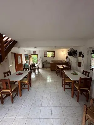 a restaurant with tables and chairs in a room at El Roble in Merlo