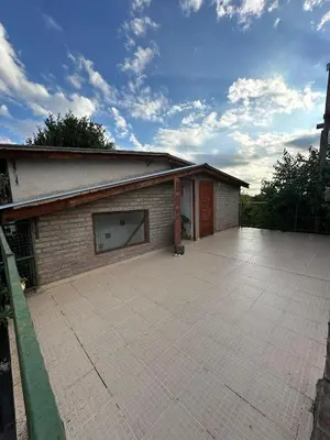 a building with a large parking lot with a garage at El Roble in Merlo