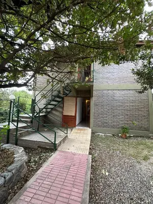a brick walkway leading to a building with a staircase at El Roble in Merlo
