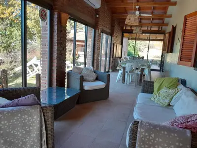 a living room with a table and chairs and a dining room at Casa frente al rio icho cruz 10 personas ideal varias parejas o familias in Villa Icho Cruz