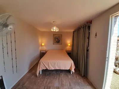 a bedroom with a bed in the corner of a room at Casa frente al rio icho cruz 10 personas ideal varias parejas o familias in Villa Icho Cruz