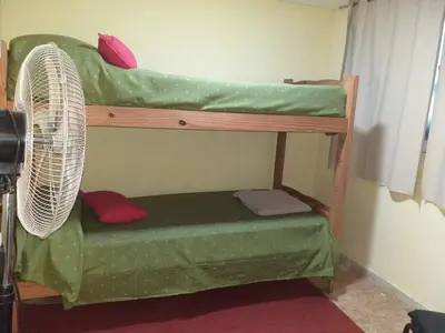 a room with two bunk beds with a fan at MT Verde Barrio Jardín in Cordoba