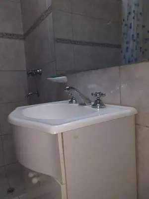 a bathroom with a white sink and a mirror at MT Verde Barrio Jardín in Cordoba