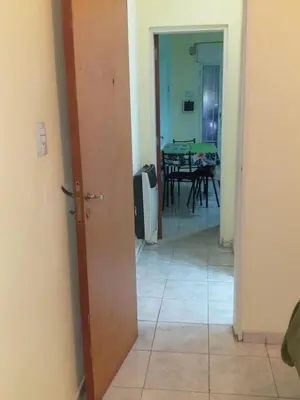 a hallway leading to a dining room with a table at MT Verde Barrio Jardín in Cordoba
