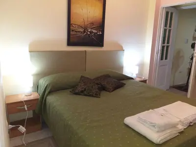 a bedroom with a green bed with two pillows on it at MT Verde Barrio Jardín in Cordoba