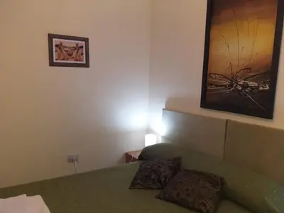 a living room with a green couch and a painting at MT Verde Barrio Jardín in Cordoba