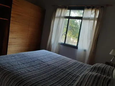 a bedroom with a bed and a window at La Roja y Barro tal vez in Los Molles