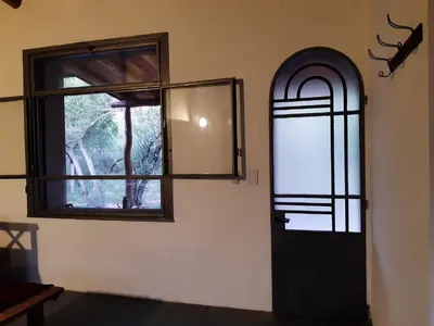 a room with a door and a window at La Roja y Barro tal vez in Los Molles