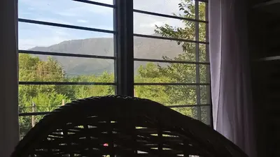 a window with a view of a mountain at Merlo2 in Merlo