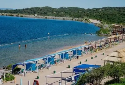 a beach with a bunch of umbrellas and the water at Merlo2 in Merlo