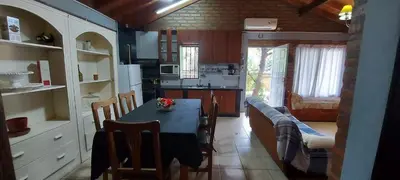 a kitchen with a table and a dining room at Merlo2 in Merlo