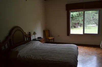a bedroom with a bed and a large window at Casa de las 3 chimeneas in Cordoba