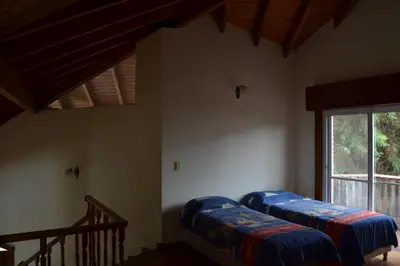 two beds in a room with a window at Casa de las 3 chimeneas in Cordoba
