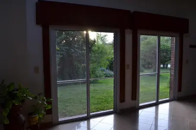 an empty room with two sliding glass doors at Casa de las 3 chimeneas in Cordoba