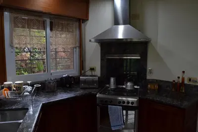 a kitchen with a stove and a counter top at Casa de las 3 chimeneas in Cordoba