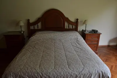 a bed in a bedroom with two night stands and two lamps at Casa de las 3 chimeneas in Cordoba