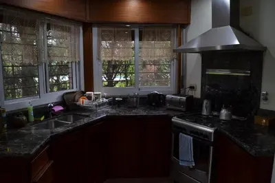 a kitchen with a sink and a stove and windows at Casa de las 3 chimeneas in Cordoba