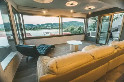 a living room with a couch and a table at casa del alto categoria vista plena lago pileta in Villa Carlos Paz