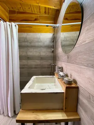 a bathroom with a sink and a mirror at Cabañas San Urbano 1 in Villa Yacanto